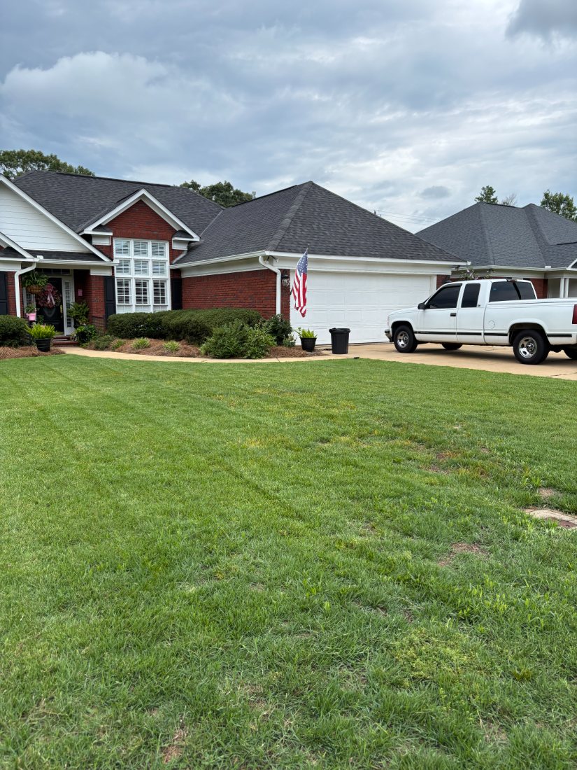 Brick house with a wide, well-kept front lawn